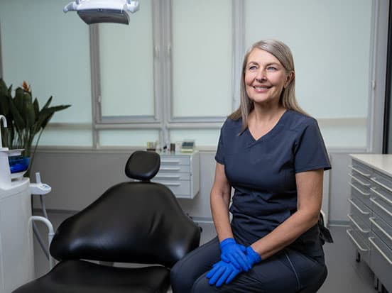 Lady dentist smiling in clinic