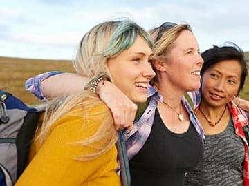 Three women walking in the hills