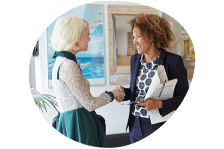 Two women shaking hands in a business setting