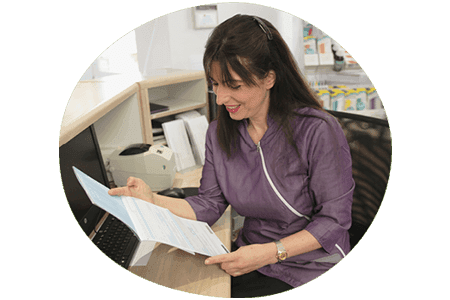 Dental practice manager working at the front desk