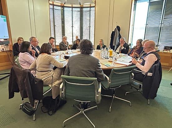 People sat at a round table during parlimentary launch event